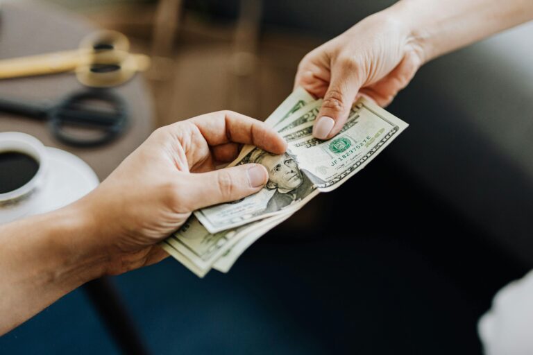 two people paying cash